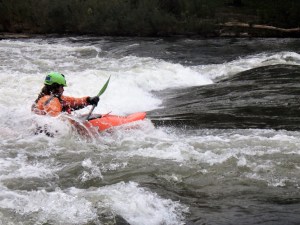 Paddler is Joseph Tyrey of Pisgah, Iowa, catches an October wave at the Charles City Whitewater Park. Tourism in Charles City has been on the rise since the opening of the state’s first whitewater river park in 2011.     Photo by Hannah Ray J